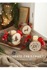Detail of wooden Christmas candle holder with glass cup, pine cones and red star decor
