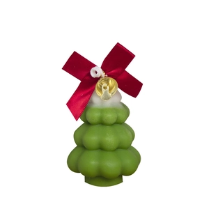 Green Christmas tree scented candle with white snow detail and golden bell decoration