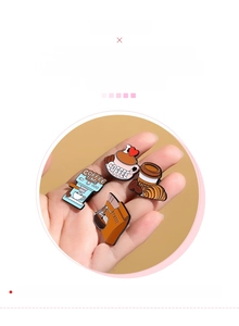 Detail of four coffee-themed enamel pins featuring a moka pot and espresso cups