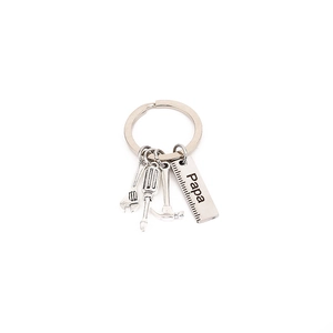 Close-up of stainless steel keychain tools featuring Papa engraving for Father's Day