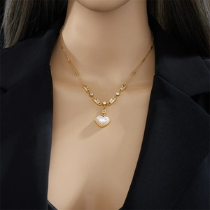 Elegant gold titanium necklace with iridescent heart pendant and sparkling zircon chain
