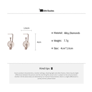 Detail view of round hollow alloy earrings with sparkling diamonds and 4cm dimensions