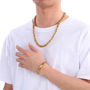 Detailed view of men's gold imperial chain necklace and bracelet set on a model