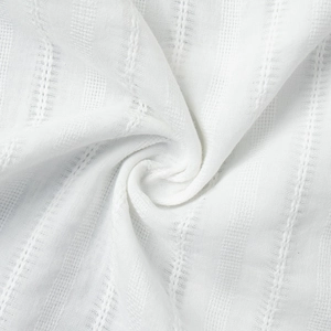 Close-up of white summer shirt showing vertical jacquard texture and lace fabric detail