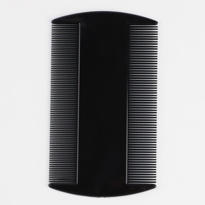 Detail view of double-sided fine-tooth black plastic flea comb for pet grooming cleaning