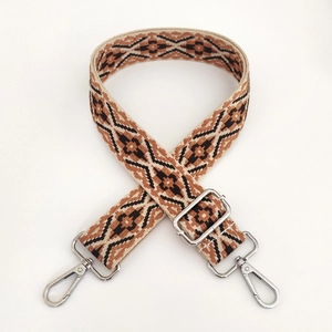 Detail of 3.8cm adjustable woven bag strap with retro geometric patterns and silver buckles