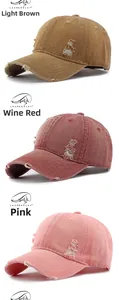 Detailed view of distressed washed cotton baseball caps in khaki, wine red, and pink colors