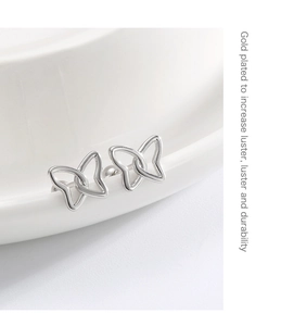 Detailed macro view of silver butterfly earring with high luster gold plated finish