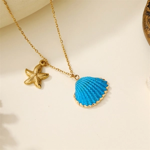 Close-up of golden beach necklace featuring a blue shell pendant and starfish charm