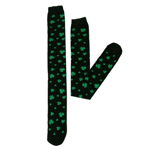 Detail of St. Patrick's Day over-knee socks featuring green shamrocks on black knit fabric