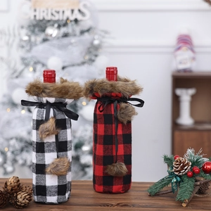 Buffalo plaid Christmas wine bottle covers with faux fur collars and decorative pom-poms