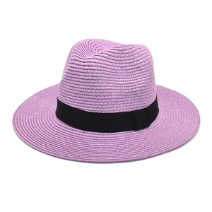 Close-up of a purple straw panama hat with a wide black grosgrain ribbon detail