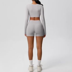 Detail of high-waist sports shorts and long-sleeve crop top back view in light mauve