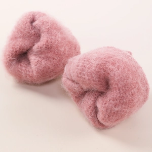 Detail shot of soft pink knit arm warmers with plush diamond hollow texture and warm feel