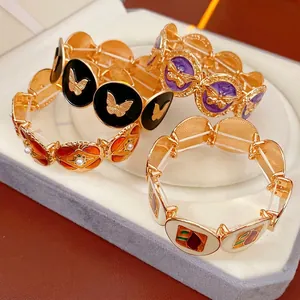Vintage enamel geometric bracelets with pearl accents in a velvet jewelry box