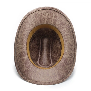 Detail view of brown western cowboy hat with cracked leather texture and inner sweatband