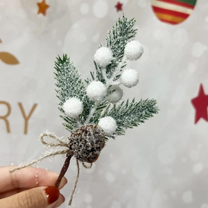 Christmas pine needle branch with white berries and natural pine cone decoration