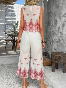 Detail of white two-piece set with pink embroidery on sleeveless top and culottes