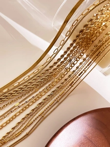Close-up showing various textures of 18K gold-plated stainless steel chain necklaces