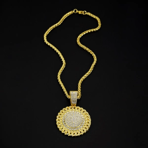 Macro shot of hip-hop gold plated medallion necklace with sparkling full diamond inlay