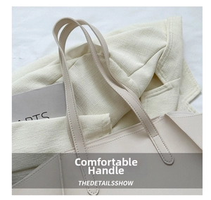 Detail of minimalist beige tote bag handle with high-quality matte leather texture