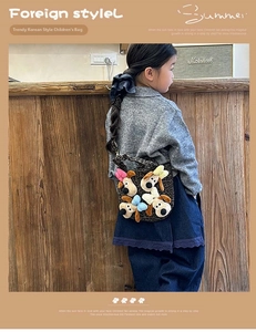 Close-up detail of children's leopard crossbody bag with cute plush dog doll decorations