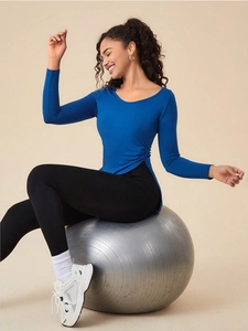 Close-up of the royal blue workout top featuring unique side ruching and slit hem detail
