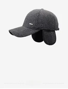 Detailed side view of winter wool baseball cap featuring ear flaps and metal logo plate