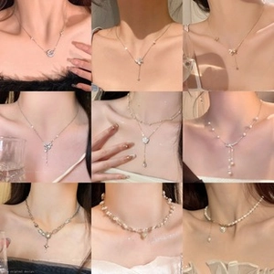Detailed collage of layered heart necklaces and pearl chokers with elegant gold chains