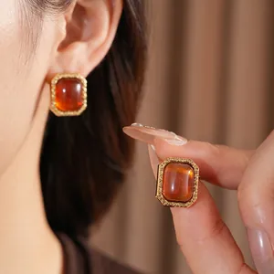 Vintage gold-plated rectangular stud earrings with amber resin and floral relief