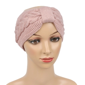 Detailed texture of pink knit headband with cable stitch pattern on display head