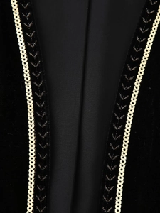 Macro shot of gold sequins and black embroidery on premium black velvet fabric