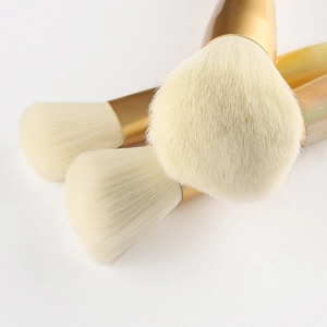 Set of 10 jade makeup brushes with gradient handles and soft bristles on white background