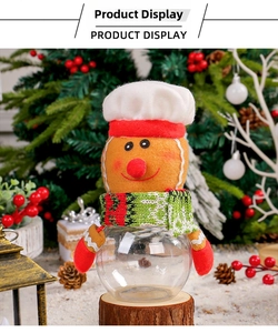 Christmas gingerbread man candy jar with a clear sphere container on a rustic wood stand