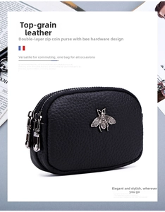 Detail of genuine leather coin purse with double zippers and silver bee hardware