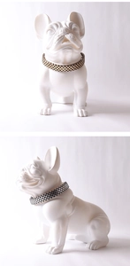Detail view of a matte white French Bulldog sculpture wearing a checkered pattern collar