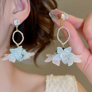 Detail view of floral drop earrings with gradient petals and sparkling zircon studs