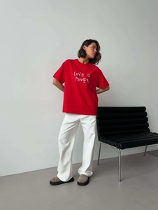 Oversized red cotton T-shirt with LOVE IS POWER print and white wide-leg trousers