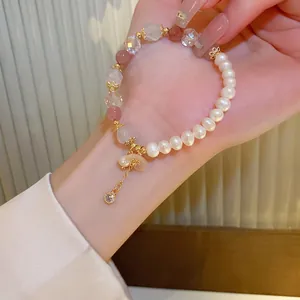 Pink strawberry quartz and white pearl beaded bracelet with a gold heart pendant