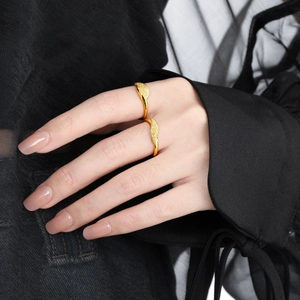 Minimalist irregular wavy gold rings with a frosted matte texture shown on model hands