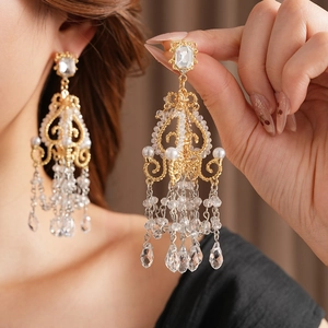 Detail of vintage chandelier earrings with crystal studs and glass tassel droplets