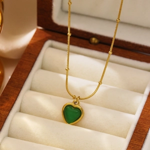 Golden snake chain necklace with heart green gemstone pendant in luxury jewelry box