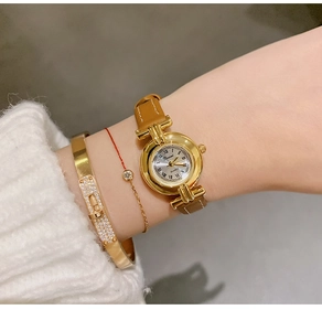 Vintage women's quartz watch with Roman numeral dial and elegant brown leather strap