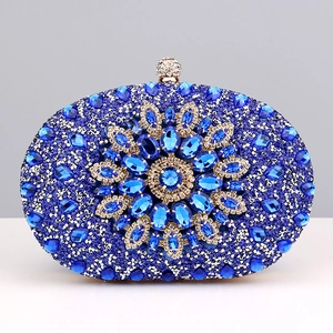 Close-up of a blue crystal evening clutch featuring a detailed 3D floral gemstone design
