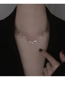 Dettaglio della collana con pendenti quadrati intrecciati in argento e cristalli su modella