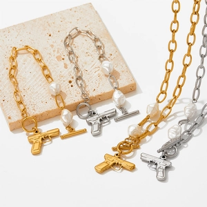Fashion pearl chain bracelet with pistol charm and OT buckle closure in gold and silver