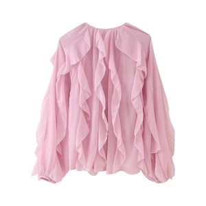 Detail shot of the ruffled layers and delicate texture on a pink V-neck long sleeve blouse