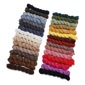 Selection of 30 colorful pleated linen scarves neatly arranged on a white background