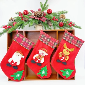 Three red felt Christmas stockings with Santa, snowman and reindeer plaid designs