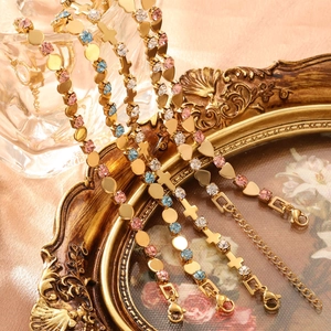 Golden emerald-style open bracelet with colorful rhinestones on a vintage frame